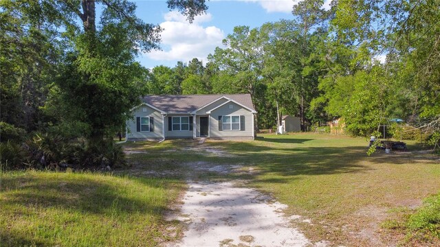 2306 NW 121st Ave, Gainesville, FL 32609 - view of front of property with driveway, a storage shed, a front lawn, and an outbuilding