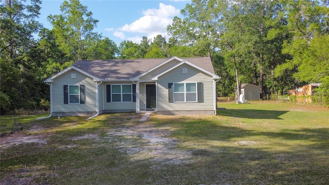 2306 NW 121st Ave, Gainesville, FL 32609 - view of front facade featuring a storage unit, a front lawn, and an outdoor structure