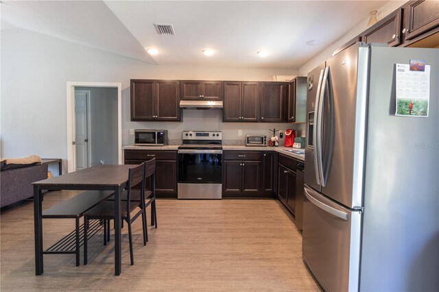 2306 NW 121st Ave, Gainesville, FL 32609 - kitchen with light wood-style floors, visible vents, stainless steel appliances, dark brown cabinets, and under cabinet range hood