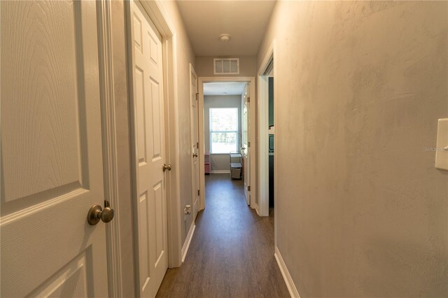 2306 NW 121st Ave, Gainesville, FL 32609 - hallway featuring visible vents, dark wood-style flooring, and baseboards