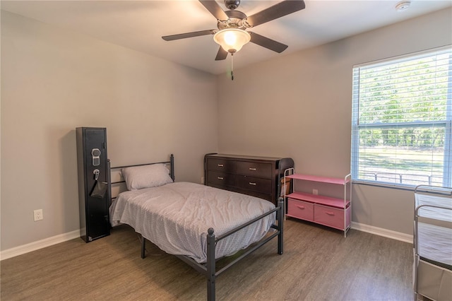 2306 NW 121st Ave, Gainesville, FL 32609 - bedroom featuring baseboards, wood finished floors, and a ceiling fan