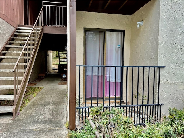 entrance to property with stucco siding