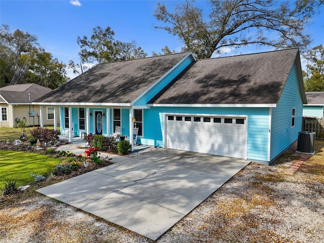 view of front of home featuring a porch, central AC unit, a garage, a shingled roof, and concrete driveway