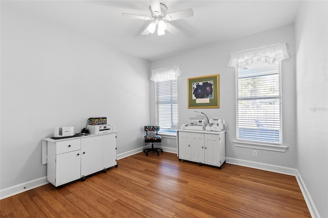 office with light wood-style flooring, baseboards, and ceiling fan