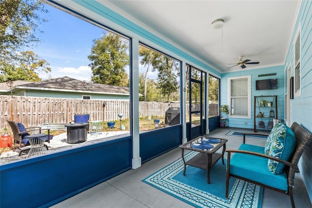 sunroom / solarium featuring ceiling fan