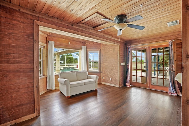 unfurnished room featuring wood ceiling, a ceiling fan, wood finished floors, and french doors