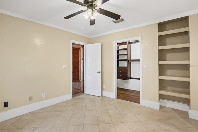 unfurnished bedroom featuring ornamental molding, visible vents, baseboards, and light tile patterned flooring