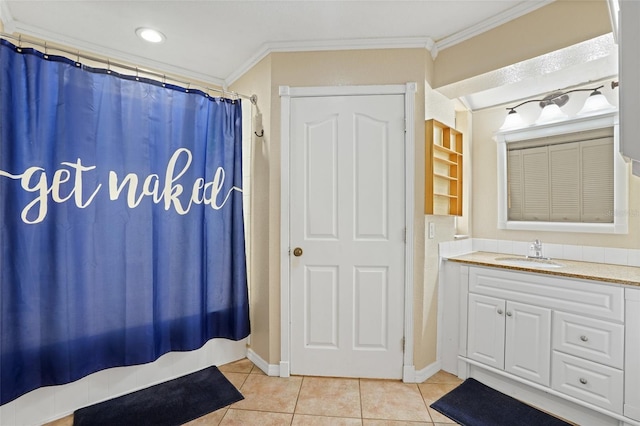 bathroom with baseboards, tile patterned flooring, vanity, and crown molding