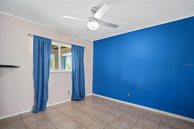 tiled empty room featuring ornamental molding, ceiling fan, and baseboards