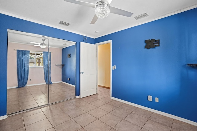 unfurnished bedroom featuring a closet, tile patterned flooring, visible vents, and a ceiling fan