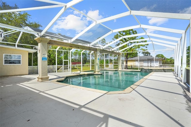 outdoor pool with a lanai and a patio area