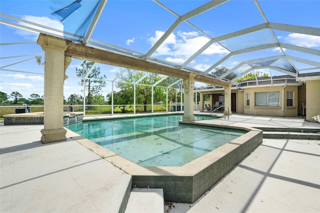 outdoor pool featuring a patio and glass enclosure