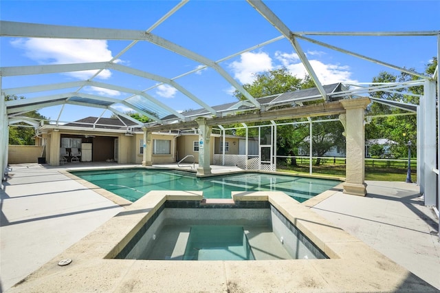 view of pool featuring glass enclosure, a pool with connected hot tub, and a patio area