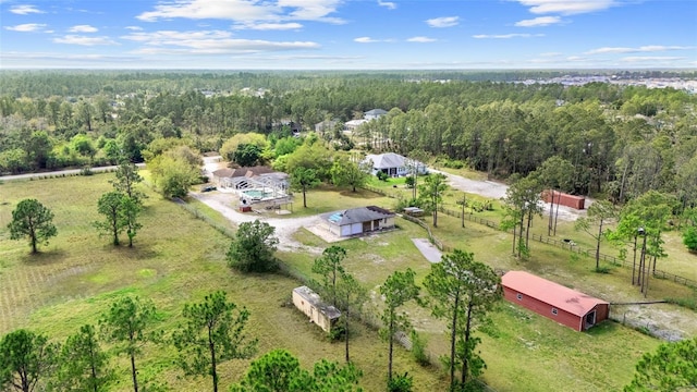 birds eye view of property featuring a forest view and a rural view