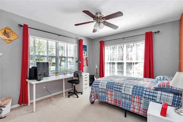 carpeted bedroom featuring a ceiling fan and baseboards