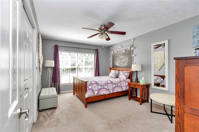 bedroom with baseboards, light carpet, and a ceiling fan