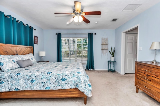 bedroom with visible vents, light carpet, baseboards, and a ceiling fan