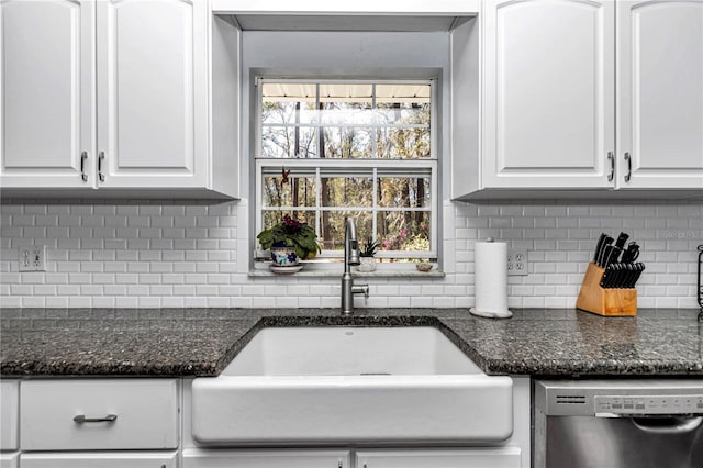 kitchen featuring a sink, backsplash, dishwasher, and white cabinetry