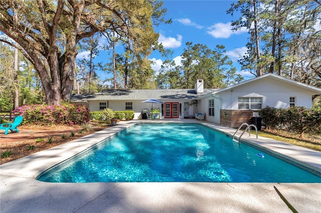 pool featuring french doors and a patio