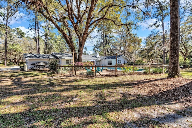 view of yard with an outdoor pool and fence