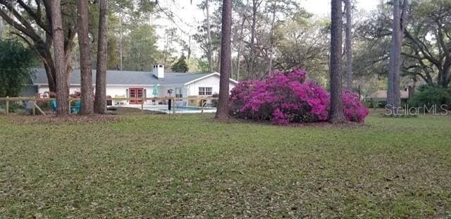 view of yard featuring an outdoor pool