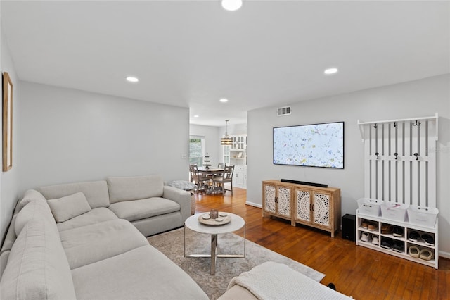 living area with recessed lighting, baseboards, and hardwood / wood-style flooring