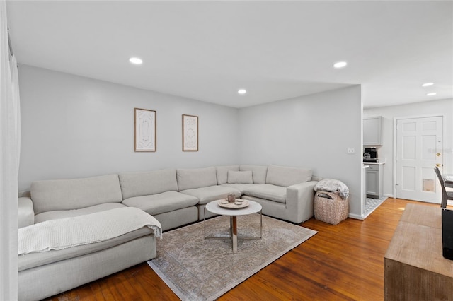 living area with recessed lighting and wood finished floors