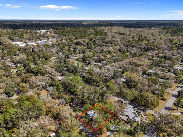 birds eye view of property with a view of trees