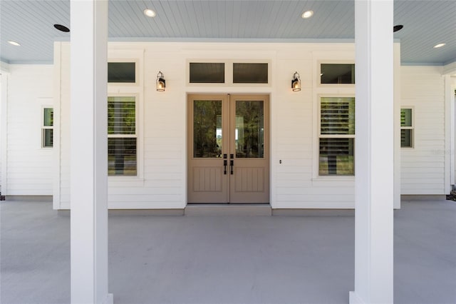 view of exterior entry with covered porch