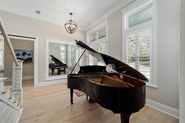 living area with stairway, visible vents, light wood-style flooring, and crown molding