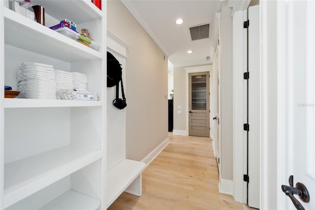 hallway featuring recessed lighting, visible vents, baseboards, and light wood-style floors