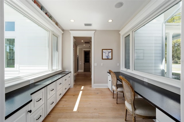 hallway with recessed lighting, light wood-style floors, visible vents, and baseboards