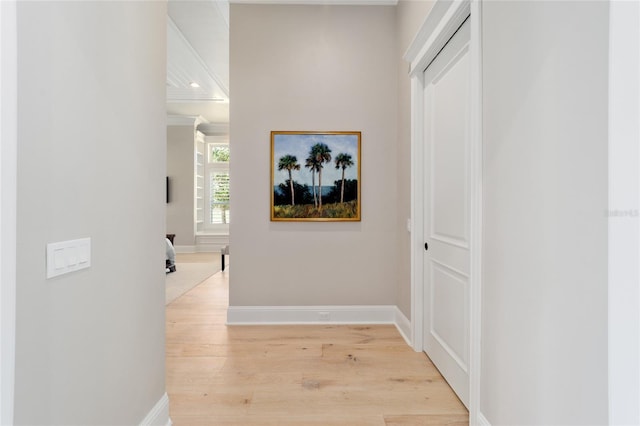 hallway with light wood-style floors and baseboards