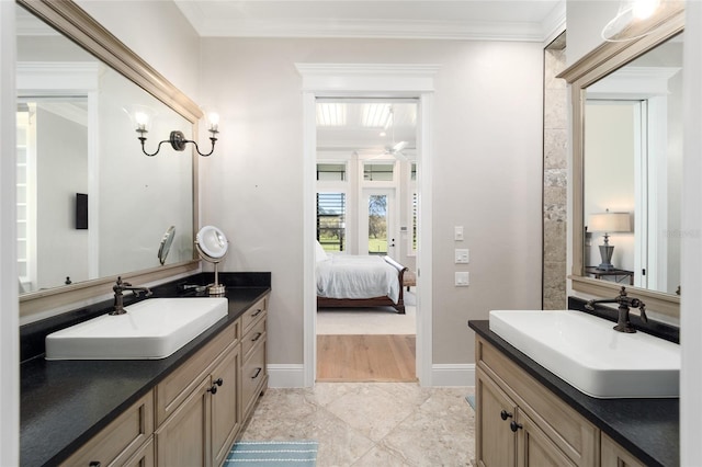 ensuite bathroom with ornamental molding, connected bathroom, and a sink