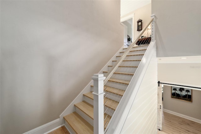 stairs featuring baseboards and wood finished floors