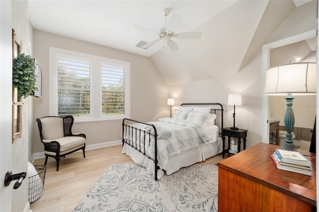 bedroom featuring a ceiling fan, lofted ceiling, light wood-style floors, and baseboards