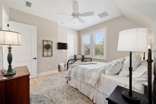 bedroom with ceiling fan, light wood-style floors, visible vents, and baseboards