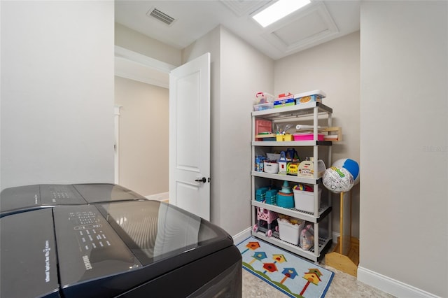 office space featuring visible vents, baseboards, attic access, and washer and clothes dryer