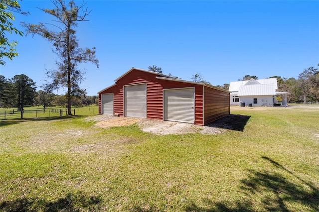 detached garage featuring fence