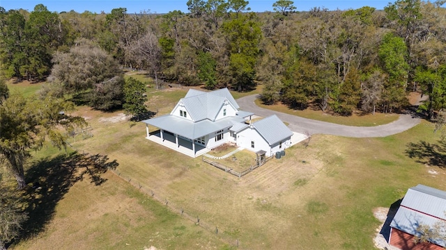 drone / aerial view with a wooded view