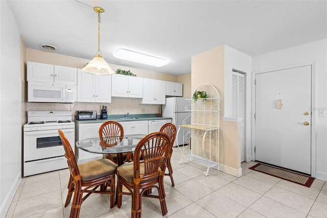 dining area with light tile patterned flooring, baseboards, and visible vents