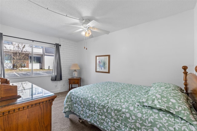 bedroom with carpet, ceiling fan, and a textured ceiling