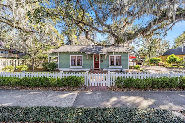 ranch-style house featuring a fenced front yard