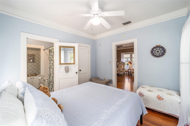 bedroom featuring visible vents, a ceiling fan, wood finished floors, and crown molding