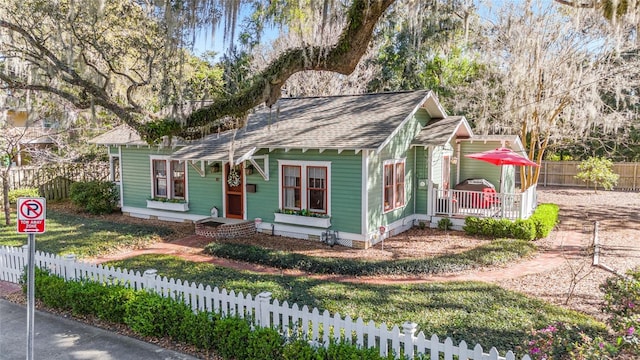 bungalow-style home featuring crawl space, fence private yard, and a shingled roof