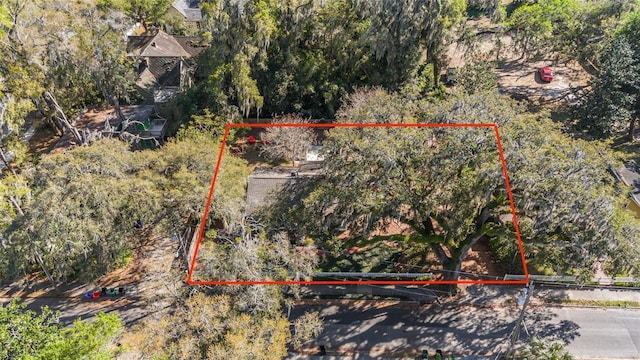 birds eye view of property with a view of trees