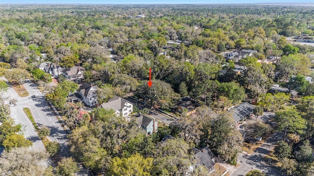 drone / aerial view featuring a wooded view