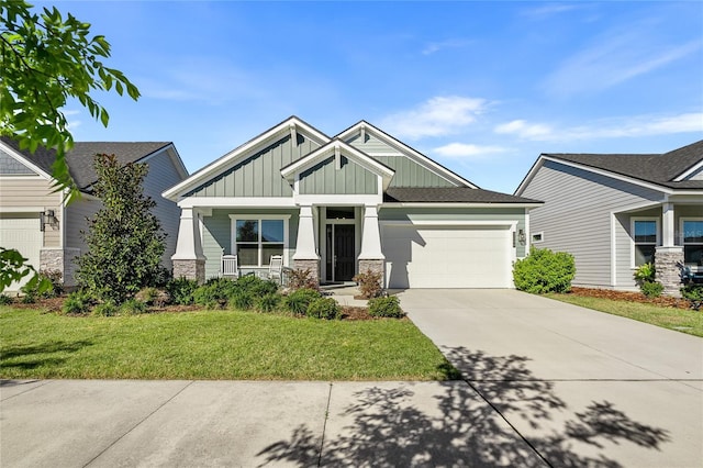 craftsman house featuring a front lawn, stone siding, board and batten siding, concrete driveway, and an attached garage