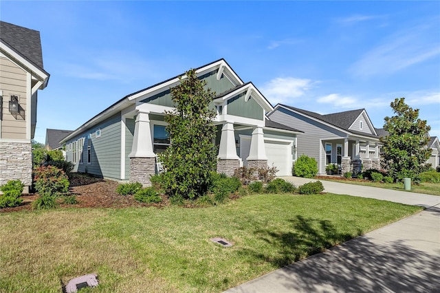 craftsman-style house featuring concrete driveway, a garage, stone siding, and a front lawn