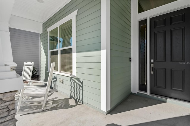 view of exterior entry with a porch